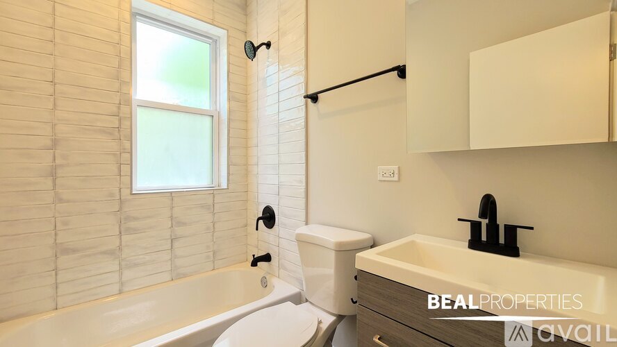 A spacious room with wooden floors and a window.