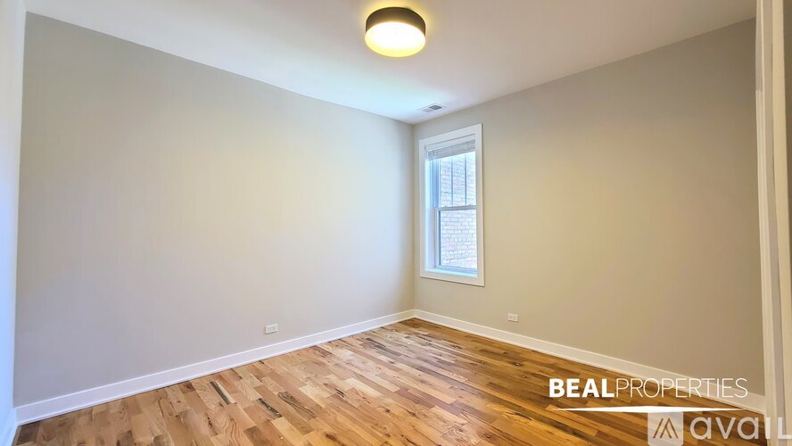 A hallway with a white door on the right and a black door on the left.