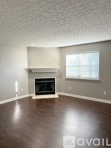 A room with a fireplace and a window.