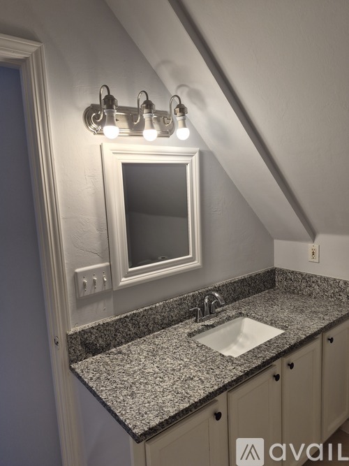 A bathroom with a toilet, sink, and shower curtain.