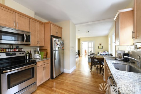 A kitchen with wooden cabinets and stainless steel appliances.