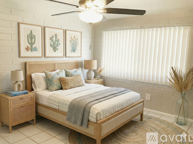 A bedroom with a bed, nightstand, and a ceiling fan.