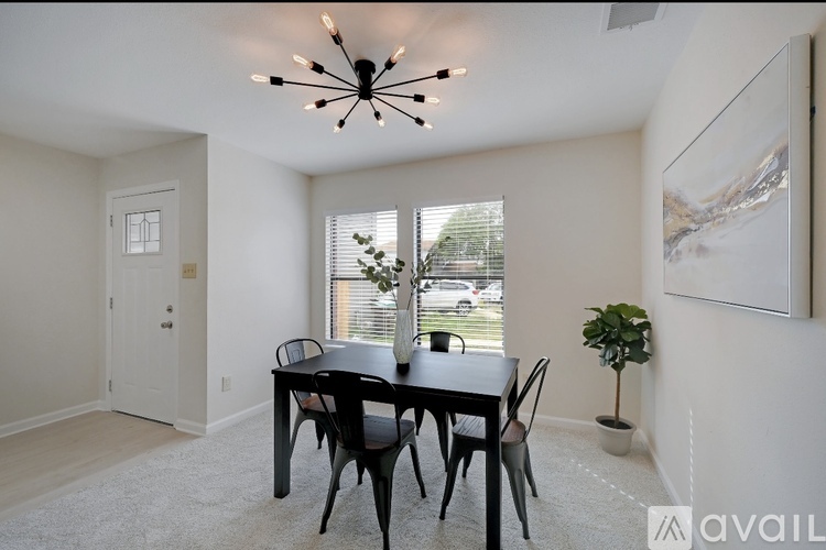 A dining room with a table set for four.