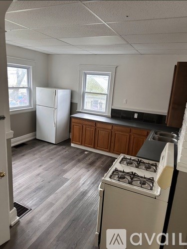 A kitchen with a white fridge and a white stove.