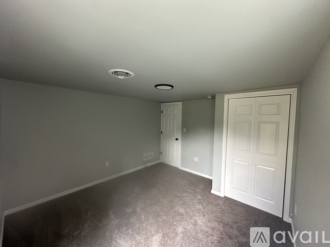 A spacious living room with a fireplace and a television.