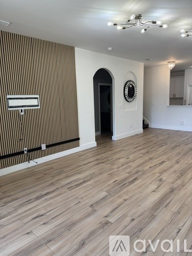 A modern living room with a dining table and chairs.