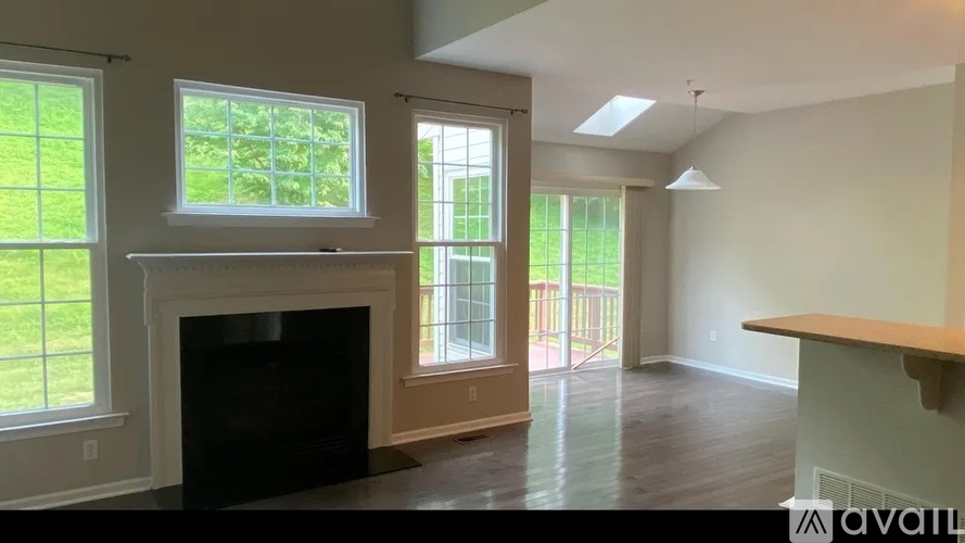 A living room with a fireplace and sliding glass doors.