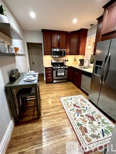 A kitchen with wooden cabinets and a stove top oven.