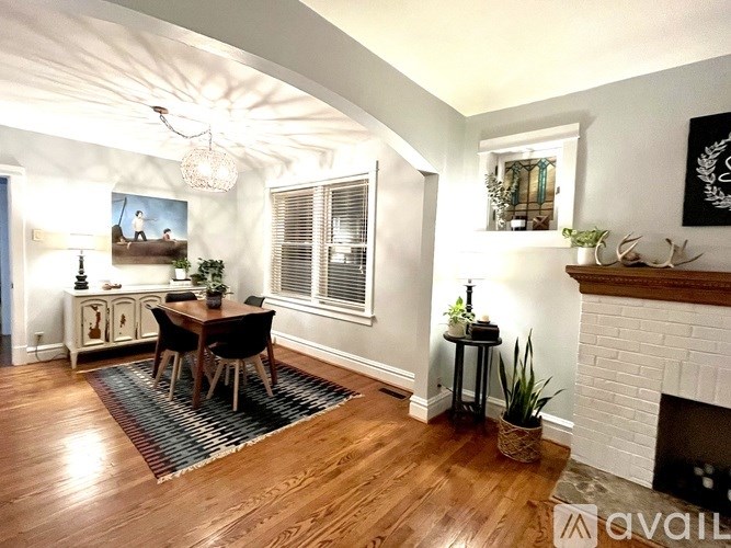 A house with a red tree in front.