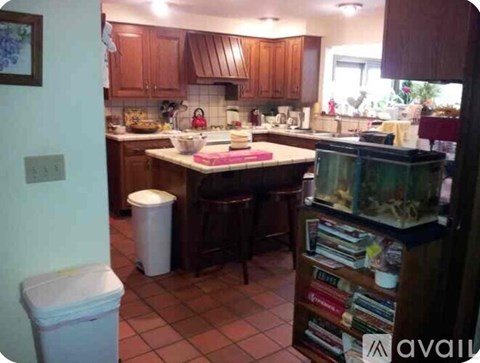 A kitchen with brown cabinets and a white countertop.
