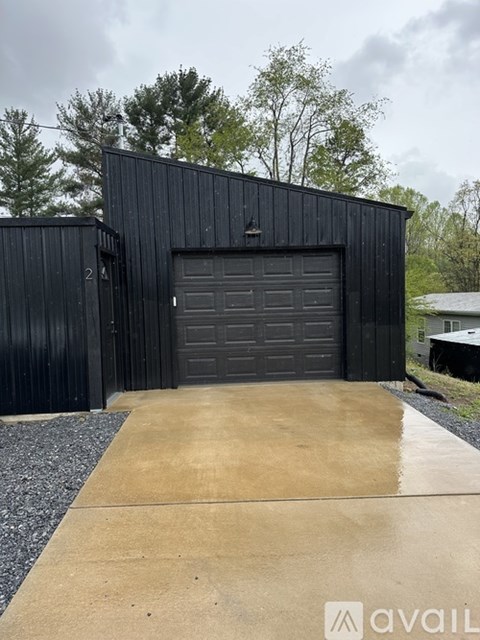 A black garage door is closed.