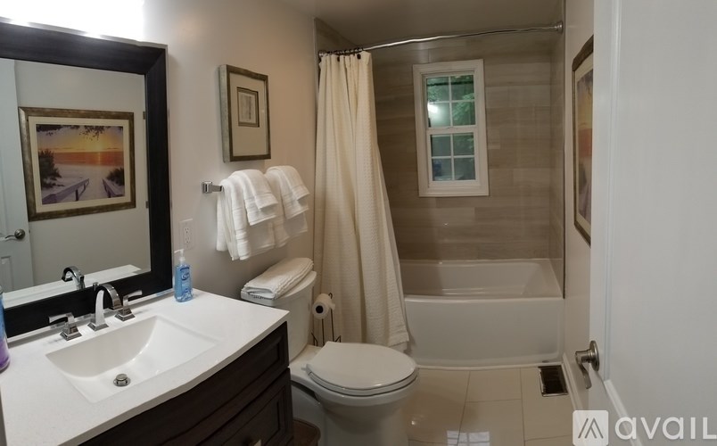 A bathroom with a toilet, sink, and shower.