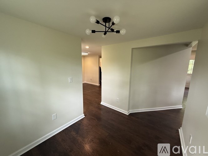 A room with wooden floors and a ceiling fan.