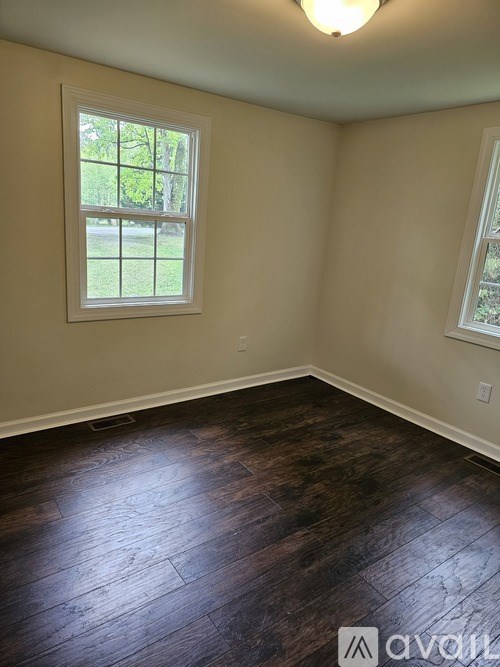 A room with wooden floors and a window.
