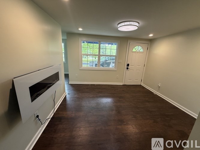 A room with a fireplace and a window with a view of the outside.