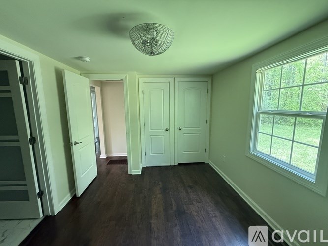 A room with green walls and a ceiling fan.