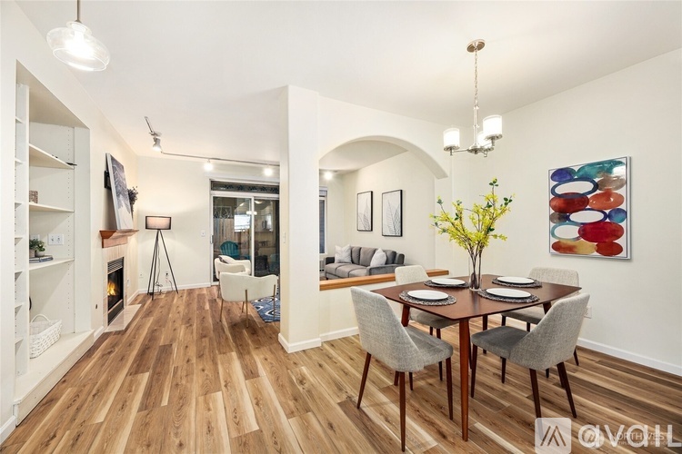 A dining room with a wooden table and chairs.