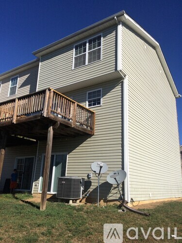 A house with a balcony and satellite dish.