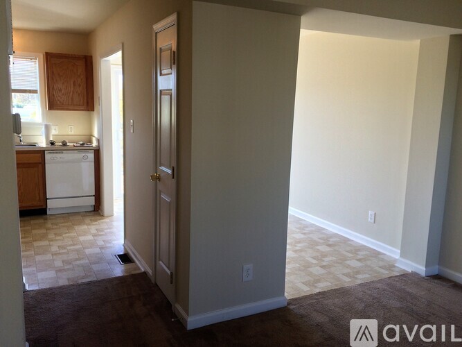 A kitchen area with a white dishwasher and a white stove top oven.