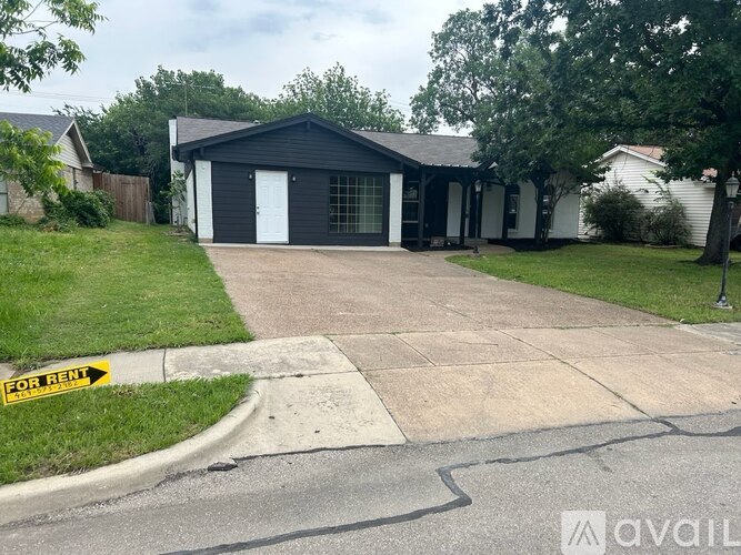 A black house with a white door is for rent.