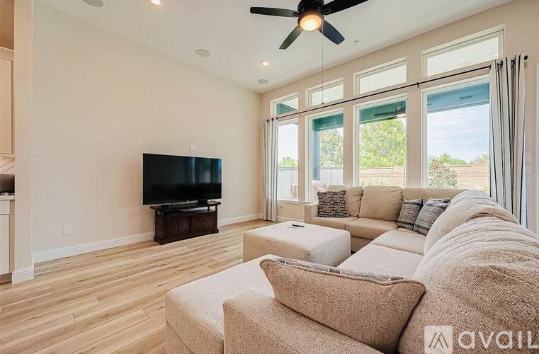 A living room with a television and a couch.