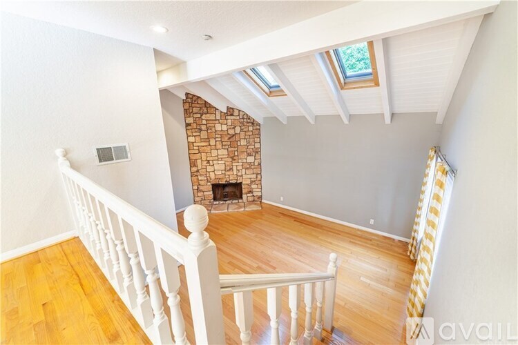 A room with a fireplace and wooden floors.
