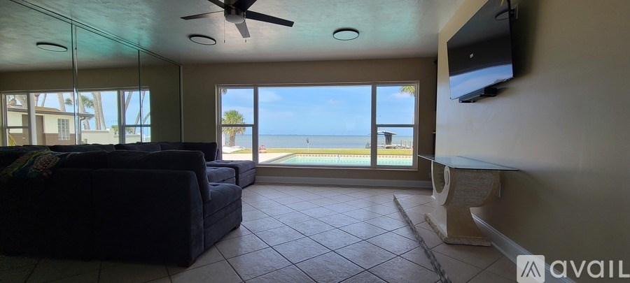 A living room with a couch and a television.