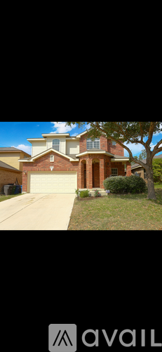 A house with a brown roof and a white garage door.