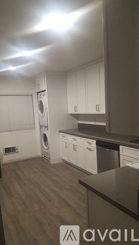 A kitchen with a washing machine and a dishwasher.