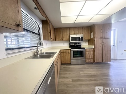 A kitchen with wooden cabinets and stainless steel appliances.