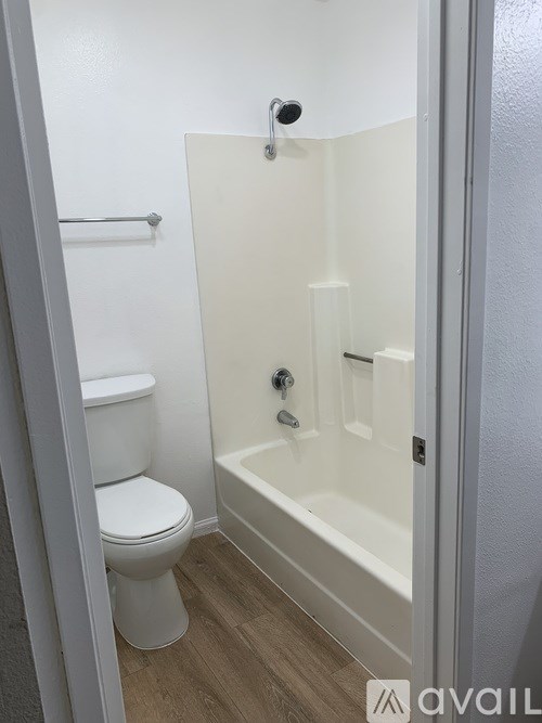 A white toilet is next to a bathtub in a bathroom.