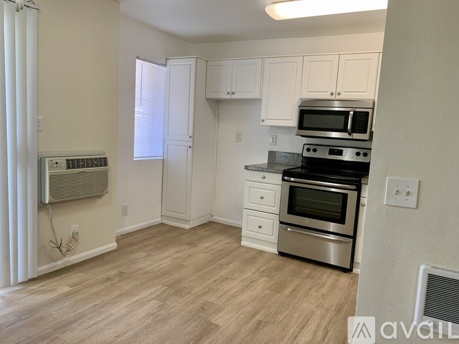A kitchen with a stove top oven and microwave.