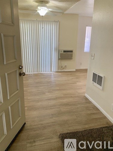 A room with a door and a rug on the floor.