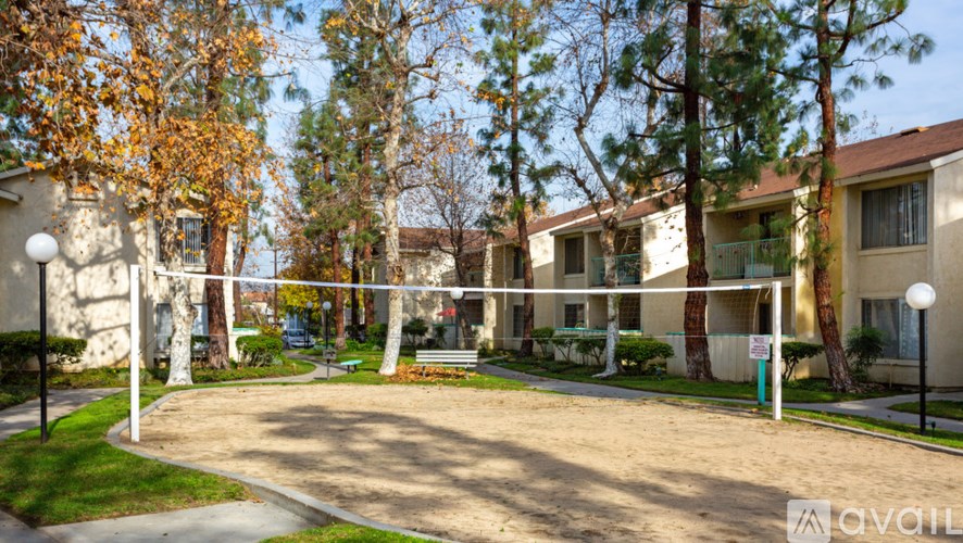Apartment complex with a dirt lot in the middle.