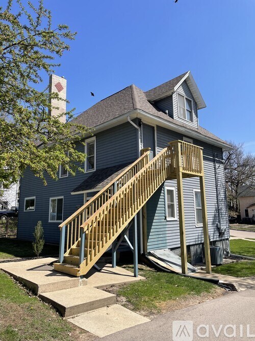 A house with a blue exterior and a yellow staircase.