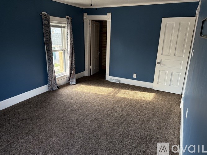 A room with blue walls and a carpeted floor.