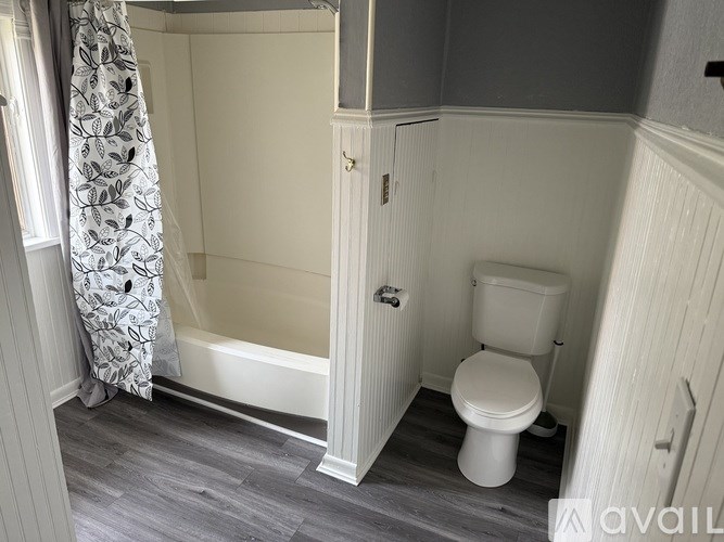 A small bathroom with a toilet and a bathtub.