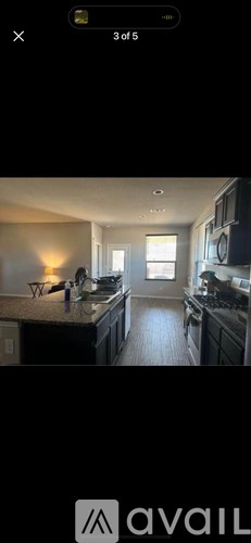 A kitchen with dark cabinets and a countertop.
