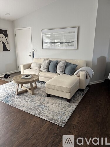 A living room with a large couch and a flat screen TV.