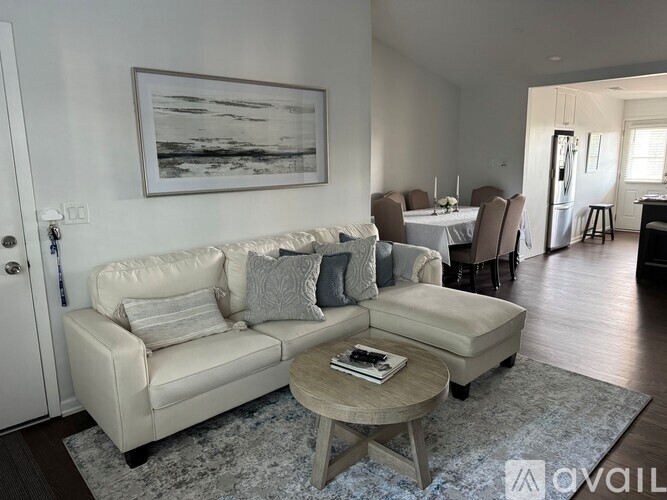 A modern living room with a grey sofa and a black chair.