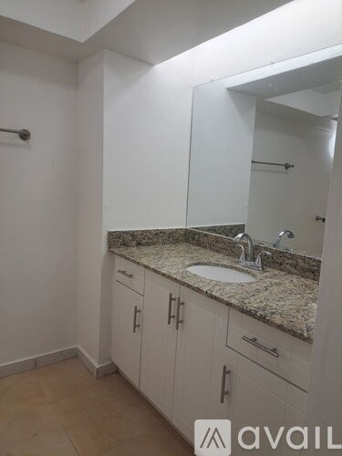 A bathroom with a sink and a mirror.