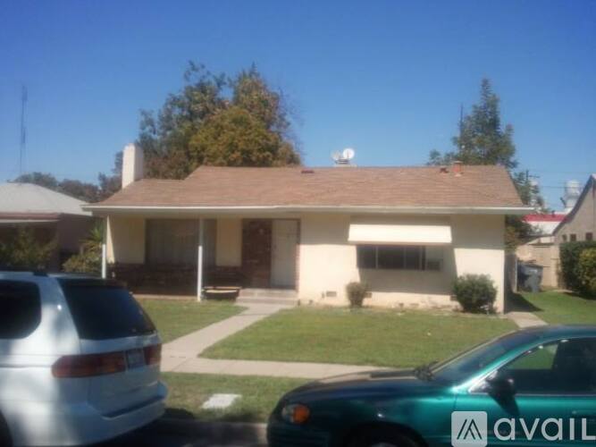 A house with a car parked in front of it.