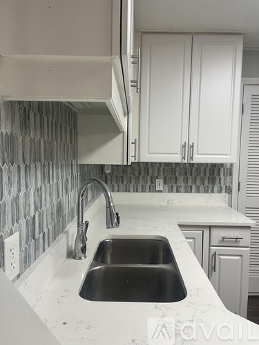 A kitchen with a sink and cabinets.