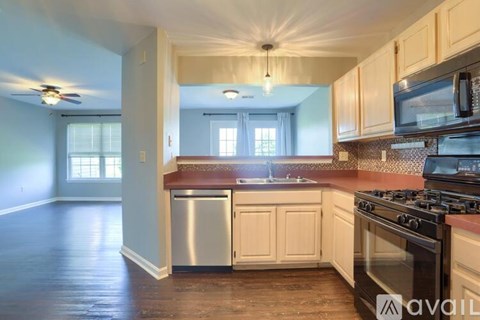 A kitchen with wooden cabinets and a stainless steel dishwasher.