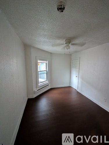 A white bathroom with a hole in the wall.
