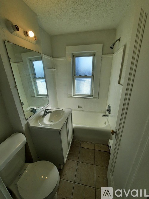 A room with a ceiling fan and a door.