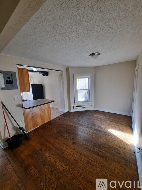 A room with wooden floors and a window.