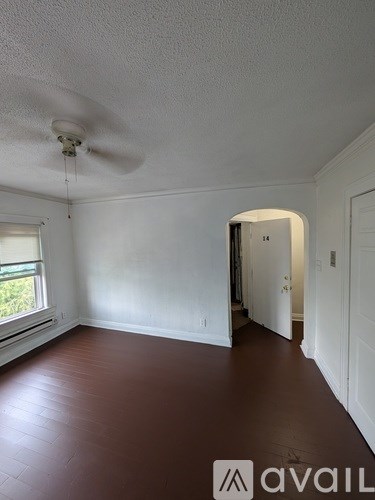 A room with a fan and a window.