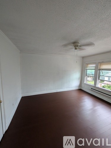 A room with a ceiling fan and a window.