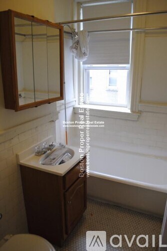 A small bathroom with a toilet, sink and window.